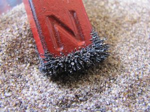 magnetite from the sand in the great sand dunes national park hangs onto a magnet