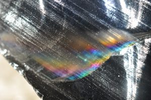 rainbow obsidian piece with rainbow colors shining