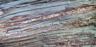 Iron Ore Rock. Bands of iron in raw form create colorful layers in a boulder