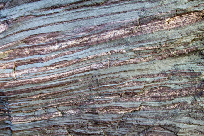 Iron Ore Rock. Bands of iron in raw form create colorful layers in a boulder, Iron Ore Rock. Bands of iron in raw form create colorful layers in a boulder