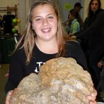 Kendall Leefler holds large peice of pumic