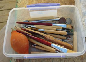 items for making jewelry gathered in a plastic bin for storing them