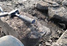 fossil hunting tools laid out on rocks that are being excavated