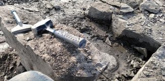 fossil hunting tools laid out on rocks that are being excavated