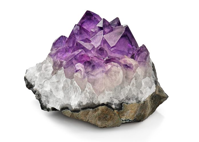 Crystal Stone macro mineral, purple rough amethyst quartz crysta amethyst crystal cluster on white background used as stones to relieve stress