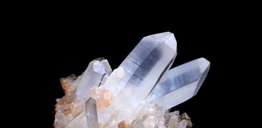 quartz specimen on black background quartz is a seven on the mohs scale of hardness