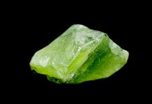 peridot crystal isolated on black