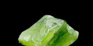 peridot crystal isolated on black