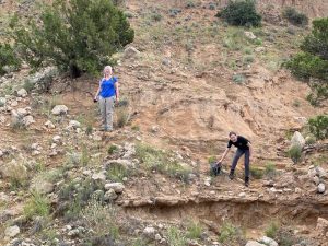 rockhounding women digging for rocks and minerals on a hillside
