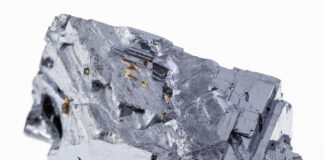 macro photography of natural mineral from geological collection - raw galena (galenite, lead glance) crystal on white background