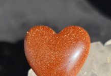 orange goldstone cabbed into a heart shape