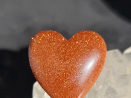 orange goldstone cabbed into a heart shape