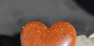 orange goldstone cabbed into a heart shape