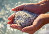 Rock Science: Minerals in Beach Sand minerals in beach sand include quartz in sand being held in hands on the beach