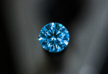 The Hope Diamond Curse A blue diamond with a black background.