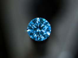 A blue diamond with a black background.