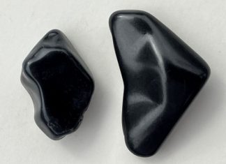 Jet Stone: History and Identification a piece of jet stone and a piece of obsidian for comparison