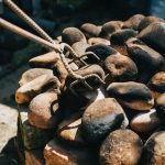 Cooking Stones: Stone Appetit! heated cooking stones being moved into place