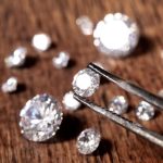 Lab-Grown Diamonds: Planting Diamond Seeds multiple lab grown diamonds with one being held up by tweezers