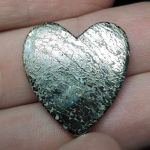 Pyritized Dinosaur Bone Fossil: What to Cut heart shaped cabochon made of dinosaur bone fossil