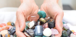 hands holding polished rocks