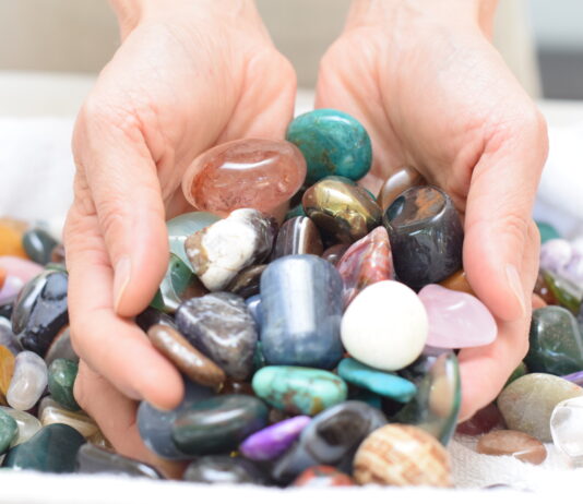 hands holding polished rocks