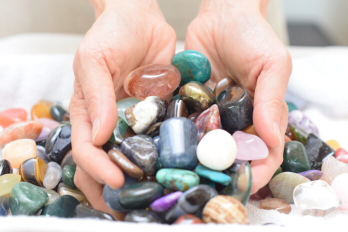 hands holding polished rocks