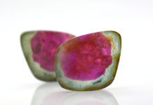 Watermelon Tourmaline Field Guide watermelon tourmalines pink and green polished and shiny on white background