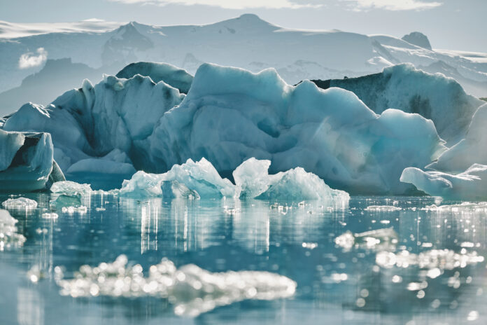 Beautiful cold landscape picture of icelandic glacier lagoon bay, Is ice a mineral. Yes. It is in full display in this Icelandic glacier lagoon bay frozen with ice.