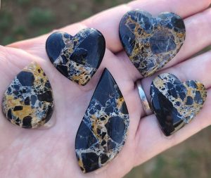 midnight buffalo cabochons on an open hand
