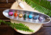 Chakra Stones: A Collector Guide seven chakra stones over wooden background, energy healing concept