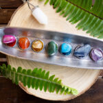 Chakra Stones: A Collector’s Guide seven chakra stones over wooden background, energy healing concept