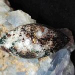 astrophyllite cabochon with mineral background