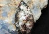 astrophyllite cabochon with mineral background