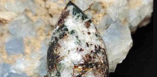 astrophyllite cabochon with mineral background
