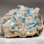 Mineral Cavansite, Blue rosettes of cavansite crystals on stilbite crystals.