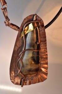 setting opals without prongs includes this opalized wood with vines and a leaf
