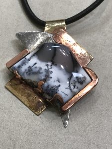 dendritic opal pendant made by setting opals without prongs