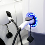 Electric car charging station. Close up of the power supply plugged into an electric car, using EV minerals, being charged