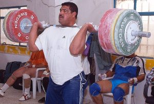 US army serviceman training with olympic weights that utilize minerals in sports