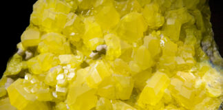 Sulphur crystals isolated on black. Large museum piece.