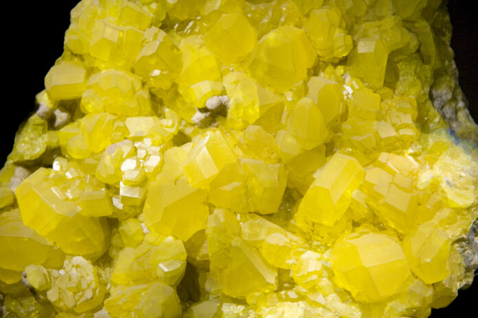 Sulphur crystals isolated on black. Large museum piece.