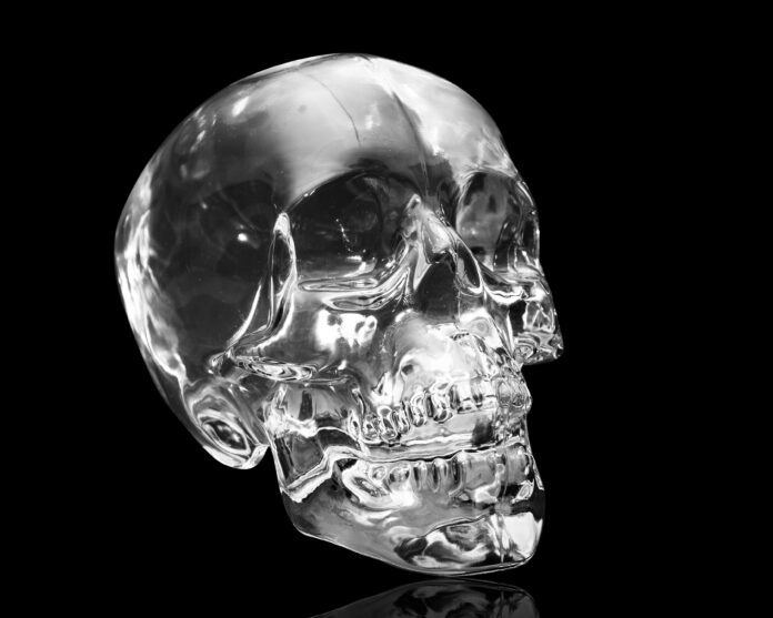 Crystal skull on black at angle ancient South American artifact Crystal skull on black at angle ancient South American artifact