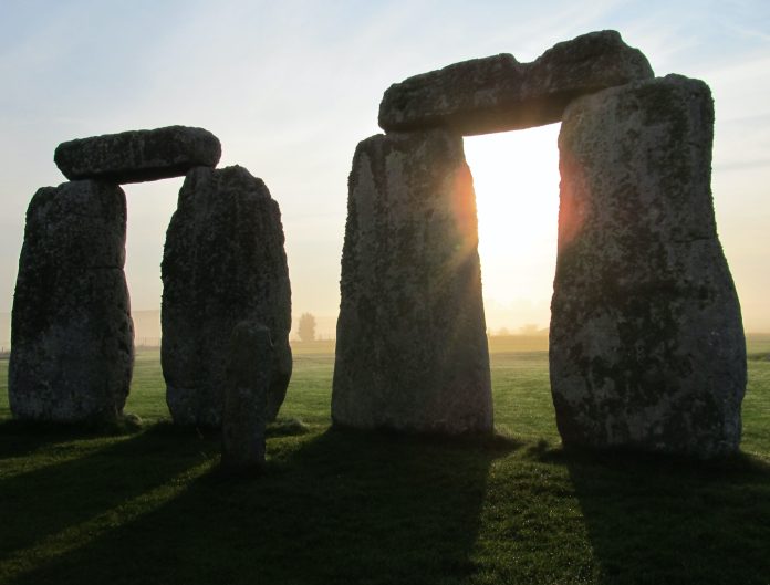 Stonehenge pairs stonehenge stones with the sun shining through