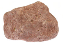 rhyolite from the Baltic Sea coast in Waabs, Germany isolated on white background