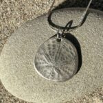 silver dollar pendant made with precious metal clay
