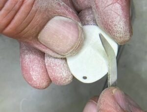 filing and sanding pendant in precious metal clay project