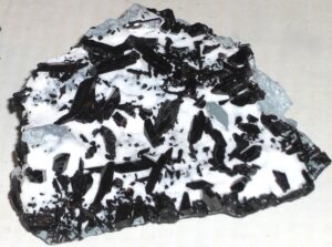 neptunite nestled in natrolite specimen