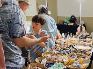Child rock collecting at a rock and gem show.