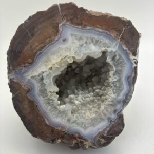 opened geode with a hollow interior and some quartz crystals